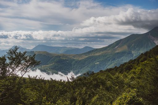 A beautiful view of a mountainous landscape under a cloudy sky