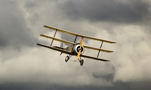 A yellow Antonov an-2 in the dark cloudy sky