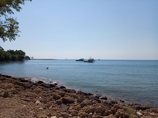 The boats in a calm lake under the blue sky