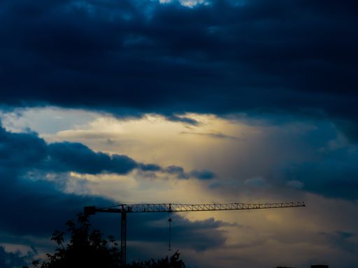 A gloomy stormy blue sky over a construction site