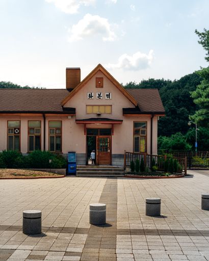 A vertical shot of Hwabon station in South Korea under a cloudy sky