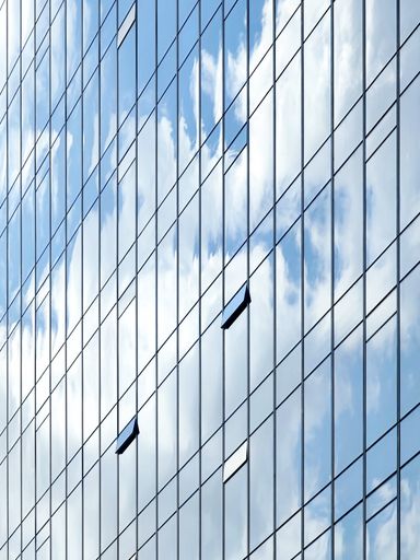 A vertical shot of the sky reflection to the modern building