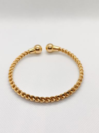 A closeup of a beautiful gold bangle on a white background