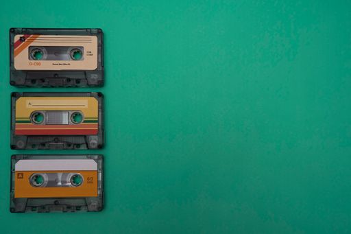 Colorful music cassettes on a dark green background