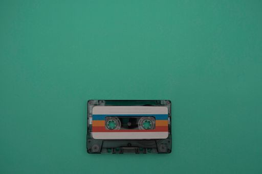 A colorful music cassette on a dark green background
