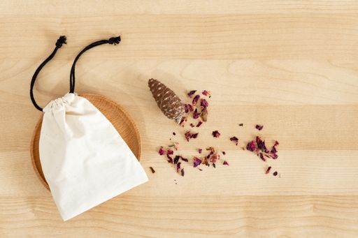 A top view of a small cloth gift bag on a wooden desk