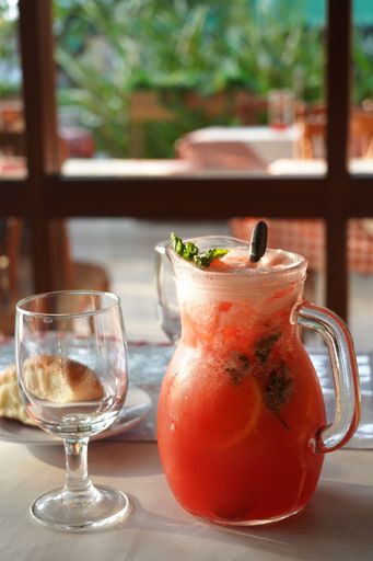 A closeup shot of a red cold lemonade with fruits