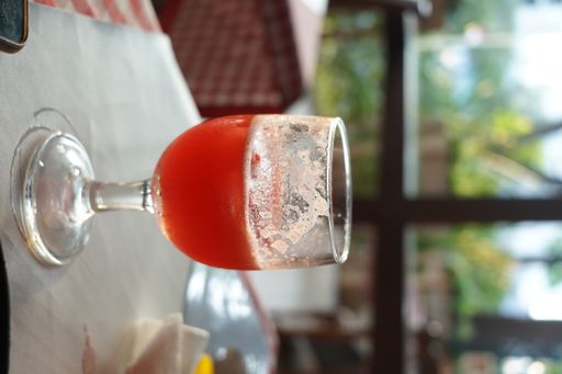 A closeup shot of a red cold lemonade with fruits