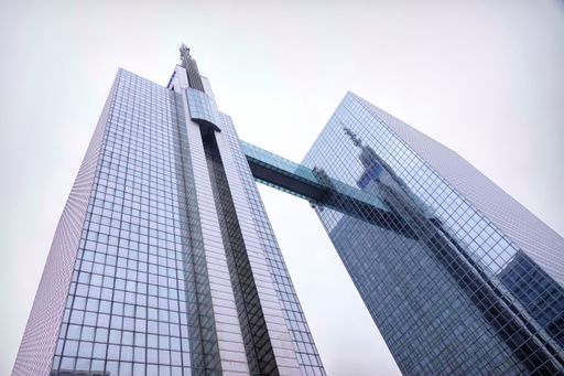 A low angle of Belgacom Proximus Modern skyscrapers with glass facades connected by a skybridge in Brussels North business district