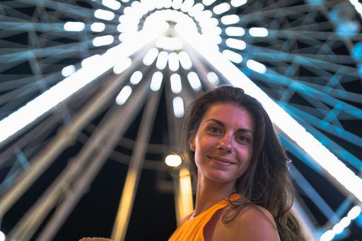 A young Caucasian female spending time in an amusement park