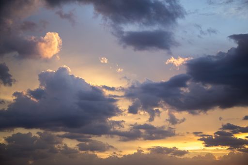 The cloudy sky during a beautiful sunset in the evening - perfect for backgrounds and wallpapers