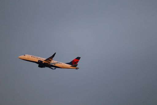 A sleek Delta Airlines Embraer E175 ascends into the clear skies above San Jose International Airport (SJC), en route to Los Angeles.