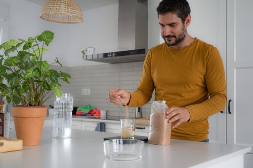 young man making homemade bread in his home kitchen