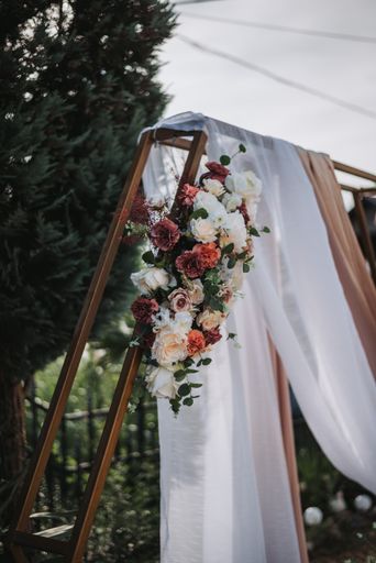 A vertical shot of a floral decoration for a wedding outdoors