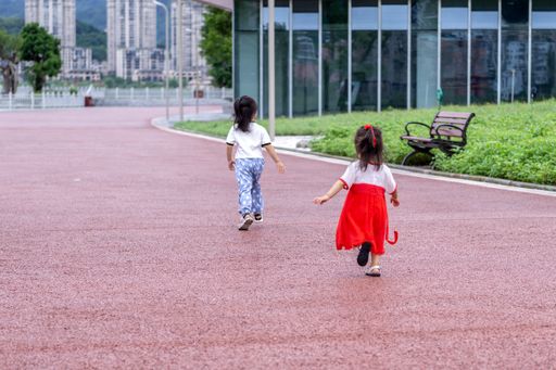 A shot of two little kids walking in a park.