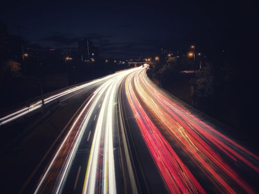 A long exposure shot of car lights on the highway at night