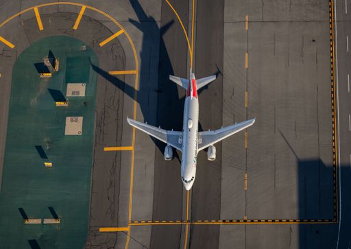 An top-down view of an American Airlines plane taxiing at Boston's Logan Intersection Airport