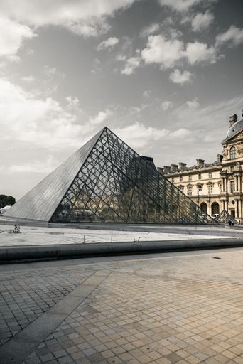 A vertical shot of the historic Louvre Museum in Paris, France