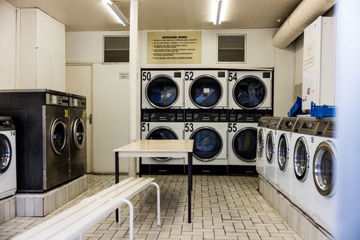 A laundromat interior with washing machines