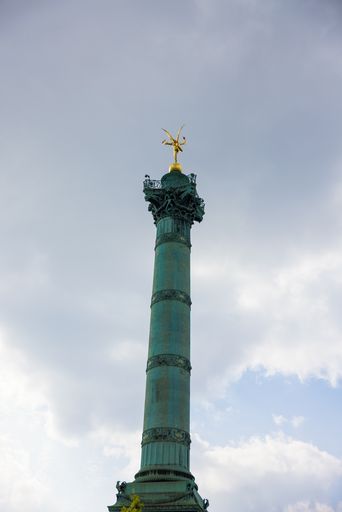 A low angle shot of July Column in Paris, France in a foggy weather