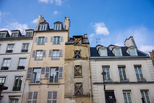 A low angle shot of a beautiful residential building with balconies in Paris, France
