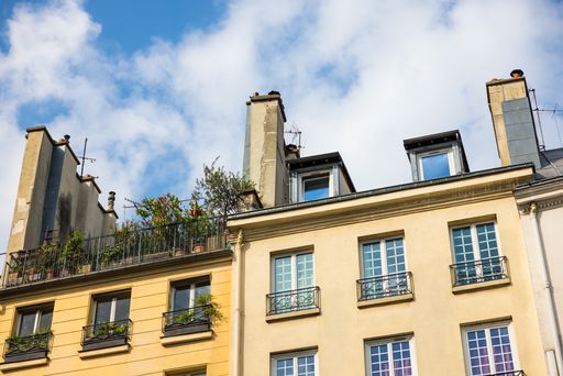 A low angle shot of a building under a blue cloudy sky