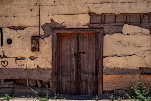 A closeup shot of an old wooden door of an ancient building under the sun
