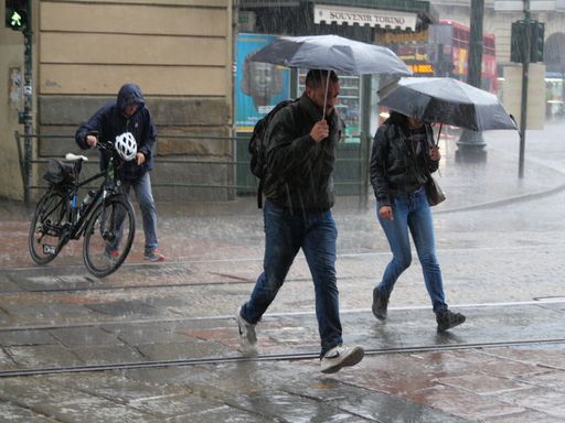 The people run under summer rain. Turin, Italy.