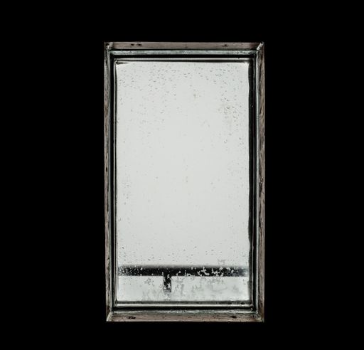 View through a window of a mountain hut. Bad weather, mist, fog and rain outside a hut, rain drops on a window.