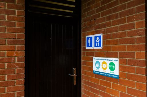 The Covid-19 signs outside a public toilet informing the public of the current hands, face, space rules from the government to keep people safe