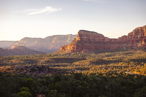 Scenic view of Sedona's red rock formations under a clear sky, showcasing natural beauty and tranquility.