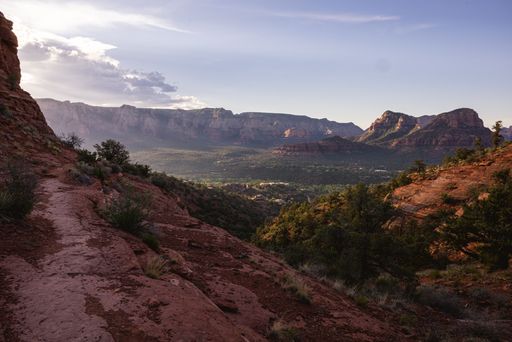 Scenic view of Sedona's red rock formations under a clear sky, showcasing the natural beauty and rugged landscape of Arizona.