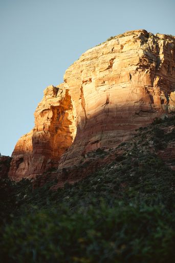 A stunning view of red rock formations in Sedona, Arizona, under a clear blue sky, highlighting the natural beauty and vibrant colors.