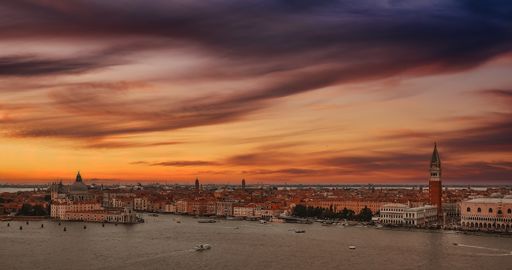 A beautiful panoramic view of Piazza San Marco, St Mark's Square in Venice, Italy at the dark orange sunset