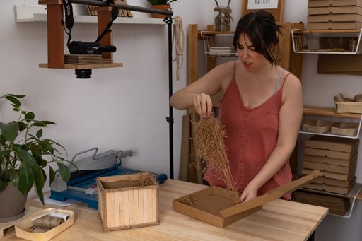 young artisan woman working in her ecological notebook workshop
