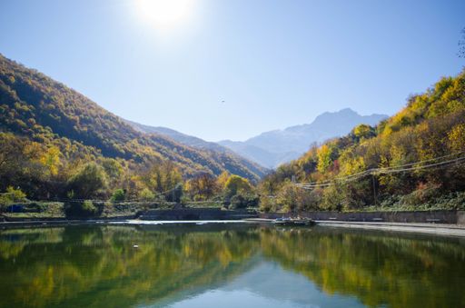 The green mountains of Southern Armenia reflected on an artificial lake at the Njdeh Park in Kapan, Armenia.