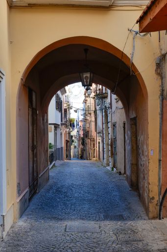 A narrow street among the old houses of a medieval village in the province of Latina.