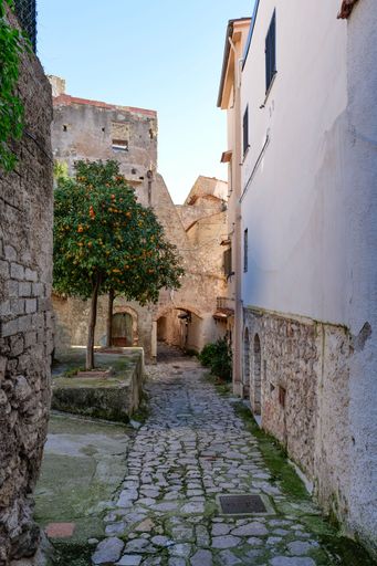 A narrow street among the old houses of a medieval village in the province of Latina.