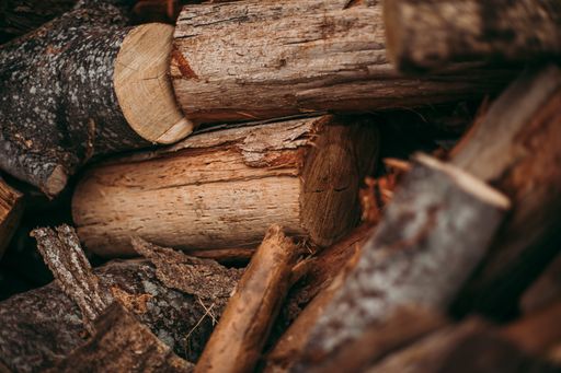 A closeup of a pile of chopped wooden logs