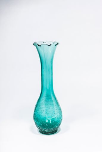 Green glass carafe on the white background in central america