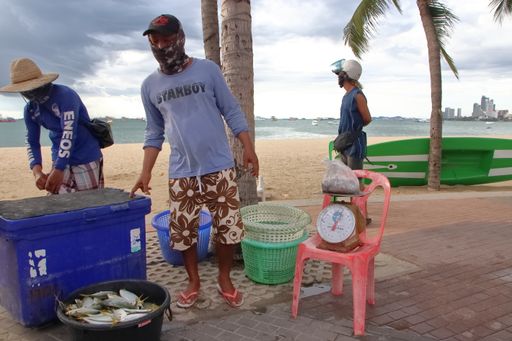 Thai fishermen selling freshly caught fish on the beach during the pandemic in Pattaya, Thailand