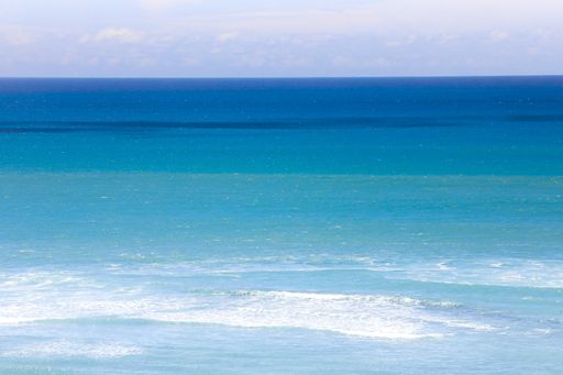 A beautiful view of the blue sea with small waves in the sun