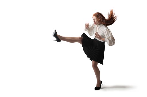 A view of a caucasian female wearing heels and dancing Italian dances on the white background