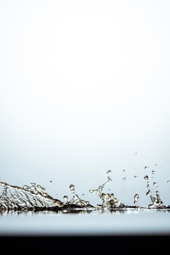 A closeup of water motion in the light background with copy space on the top
