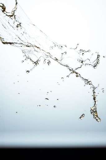 The clear water splashing in the light background