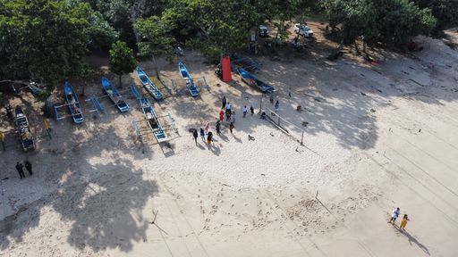 The fishing boats docked at Tanjung Papuma sandy beach after participating in the boat festival