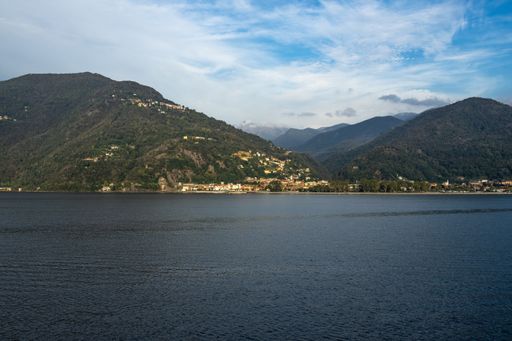 A shot of a landscape of Lago Maggiore at sunset from a ferry boat cruising on Maggiore lake, Italy