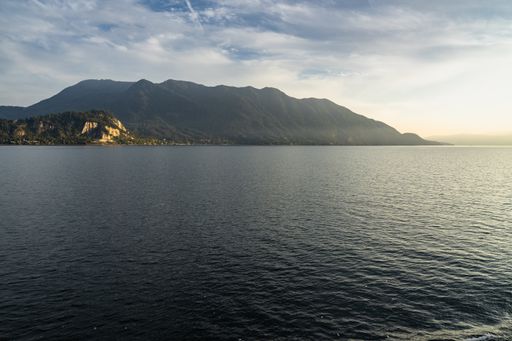 A shot of a scenic view of the Lake Maggiore shot from a ferry boat cruising Luino to Stresa, Piedmont, Italy