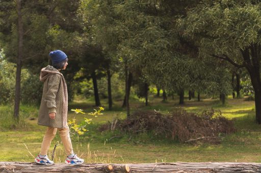 A young woman walking through nature, enjoying the scenery