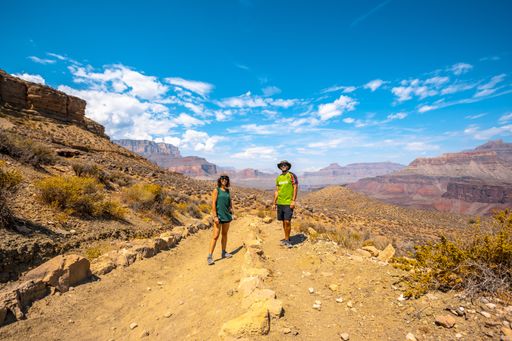 A beautiful shot of a couple together in the Grand Canyon under a blue sky